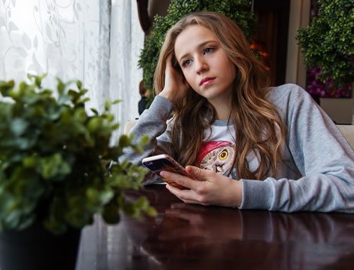 Image of girl holding cell phone
